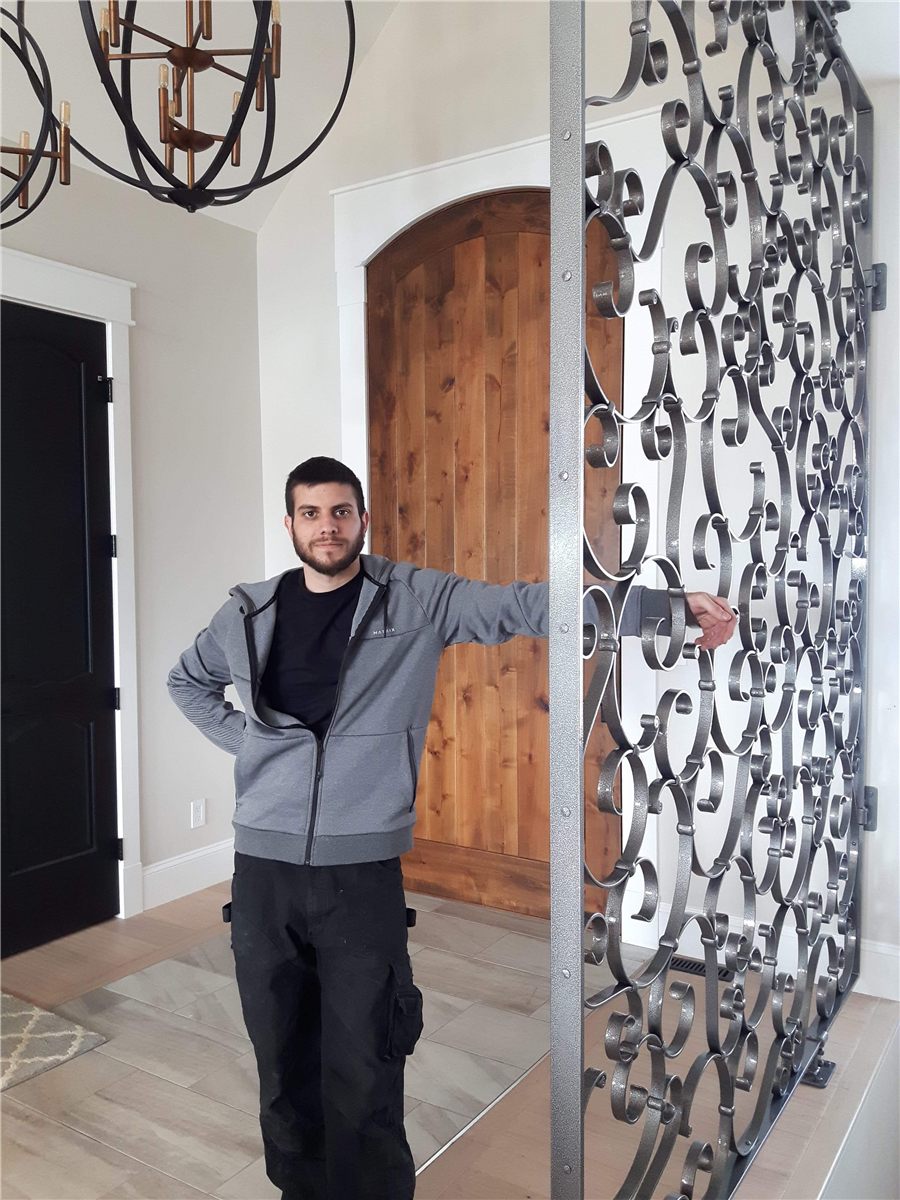 Alessio Zilli at the forged scrollwork feature wall