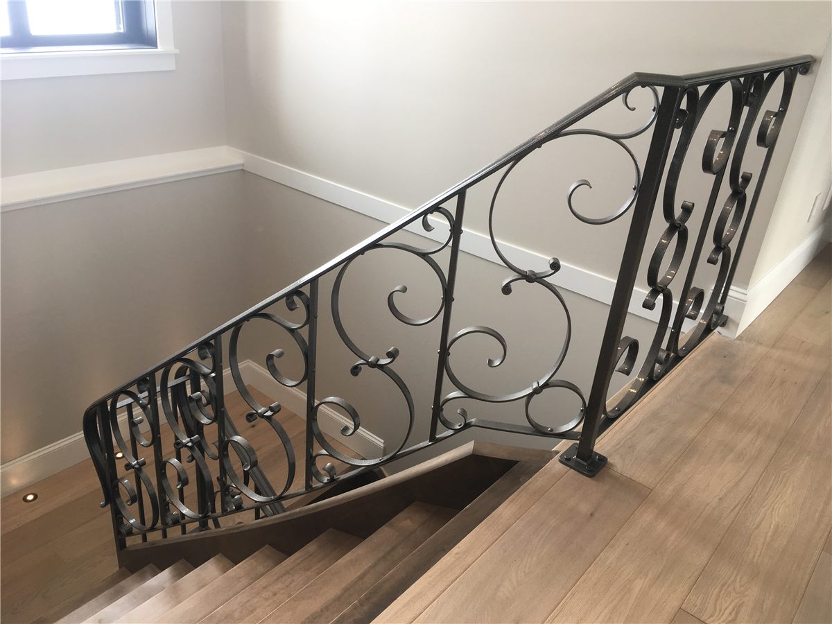 Hand-forged scrollwork railing and staircase